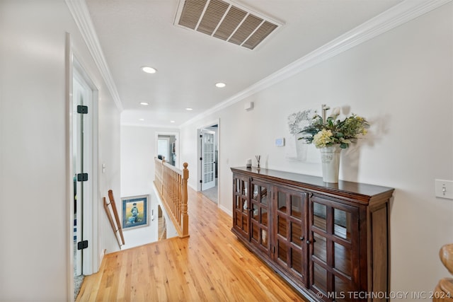 hallway featuring ornamental molding and hardwood / wood-style floors