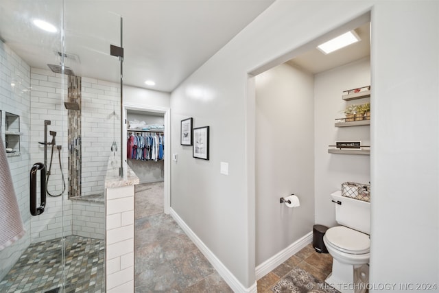 bathroom with toilet and walk in shower