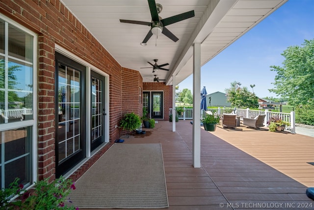 deck with a porch and ceiling fan