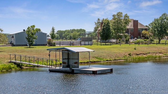 view of dock featuring a lawn and a water view