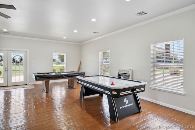 playroom featuring ornamental molding, heating unit, and a wealth of natural light