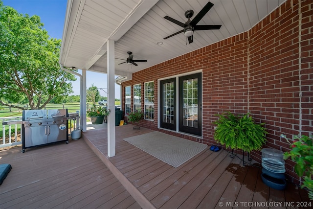 wooden deck with ceiling fan and grilling area