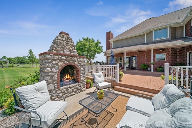 deck featuring exterior fireplace