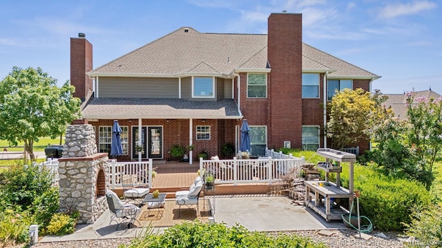 back of property featuring a patio area and a wooden deck