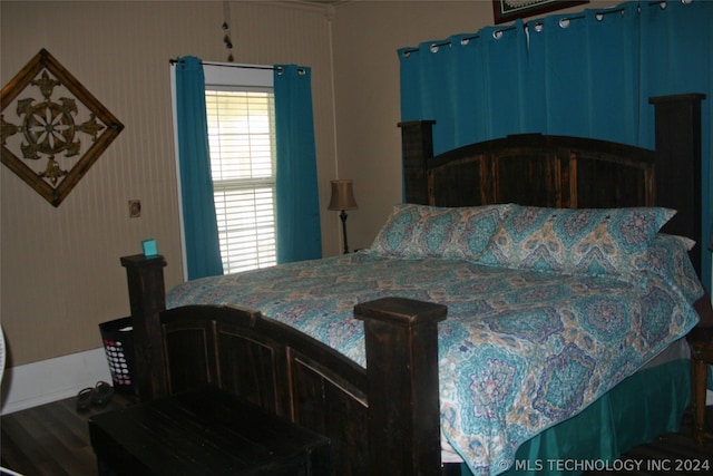 bedroom with hardwood / wood-style floors and multiple windows