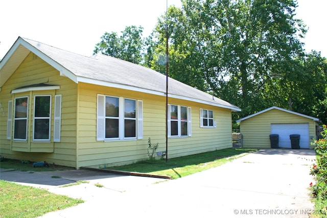 view of front facade with an outbuilding and a garage