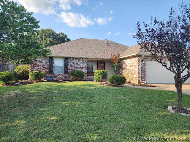 ranch-style home featuring a front yard and a garage