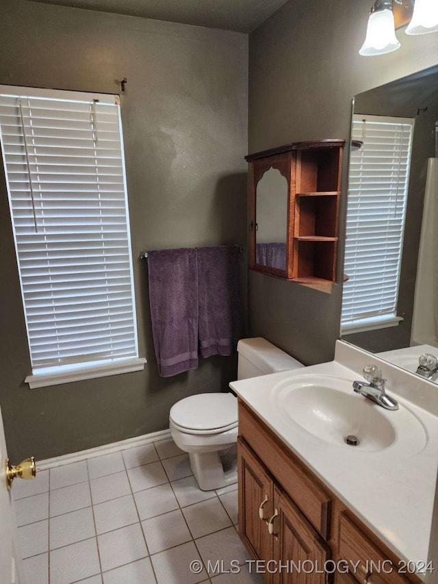 bathroom featuring tile patterned floors, vanity, and toilet