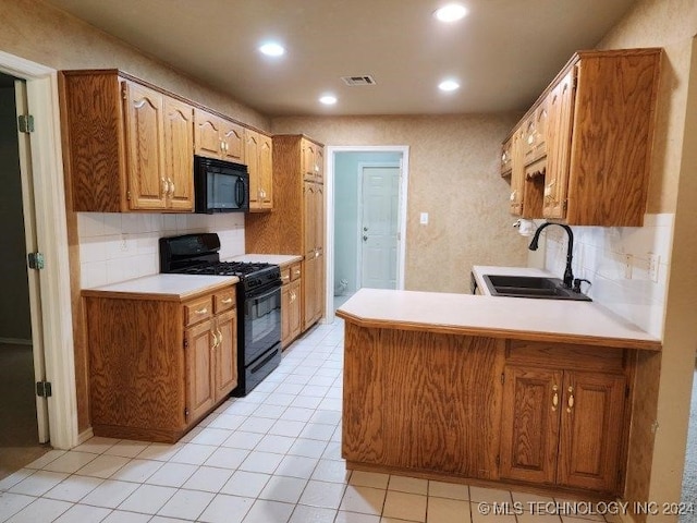 kitchen with sink, tasteful backsplash, kitchen peninsula, light tile patterned floors, and black appliances