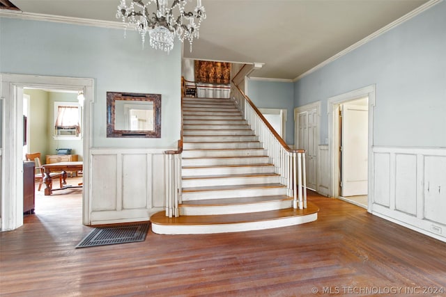 stairway featuring crown molding and an inviting chandelier