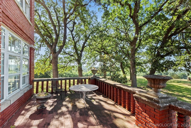 wooden terrace featuring a patio