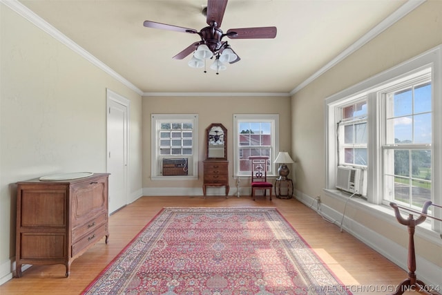 sitting room with ceiling fan, cooling unit, light hardwood / wood-style floors, and ornamental molding