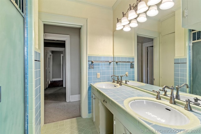 bathroom with vanity, tile patterned floors, tile walls, and crown molding