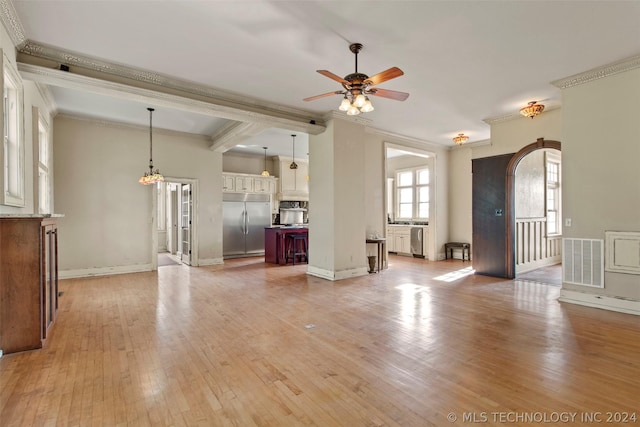 unfurnished living room featuring ceiling fan, light hardwood / wood-style floors, and crown molding