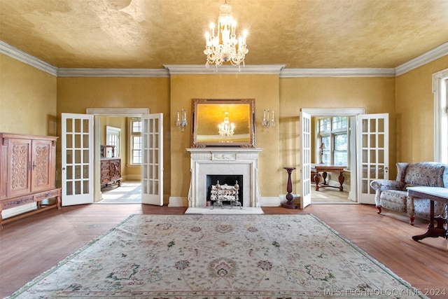 living room with crown molding, french doors, and wood-type flooring