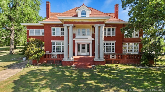 neoclassical home with a front lawn