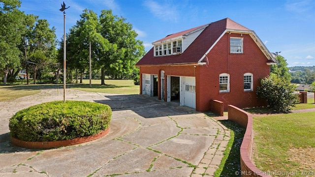 view of property exterior featuring a lawn and a garage