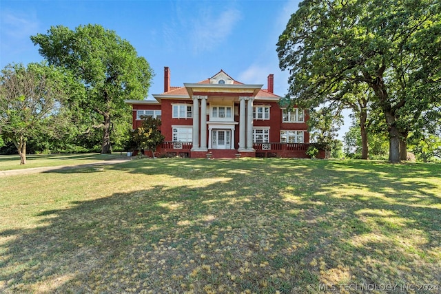 greek revival house with a front lawn