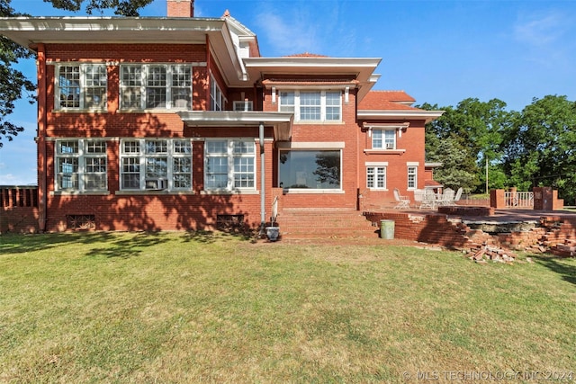 rear view of house with a lawn