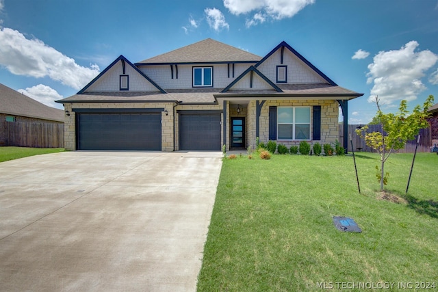 view of front of home with a front yard and a garage