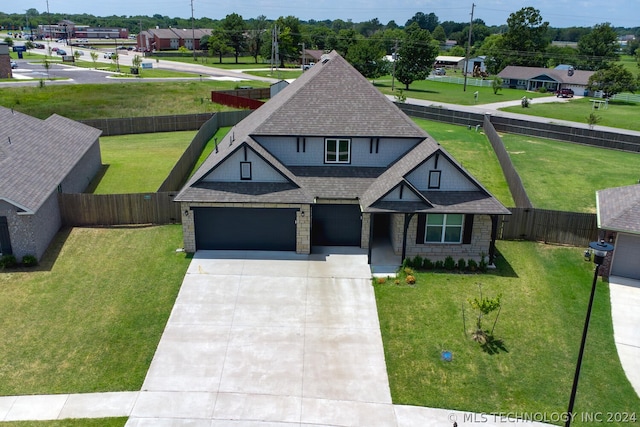 view of front of property with a garage and a front lawn