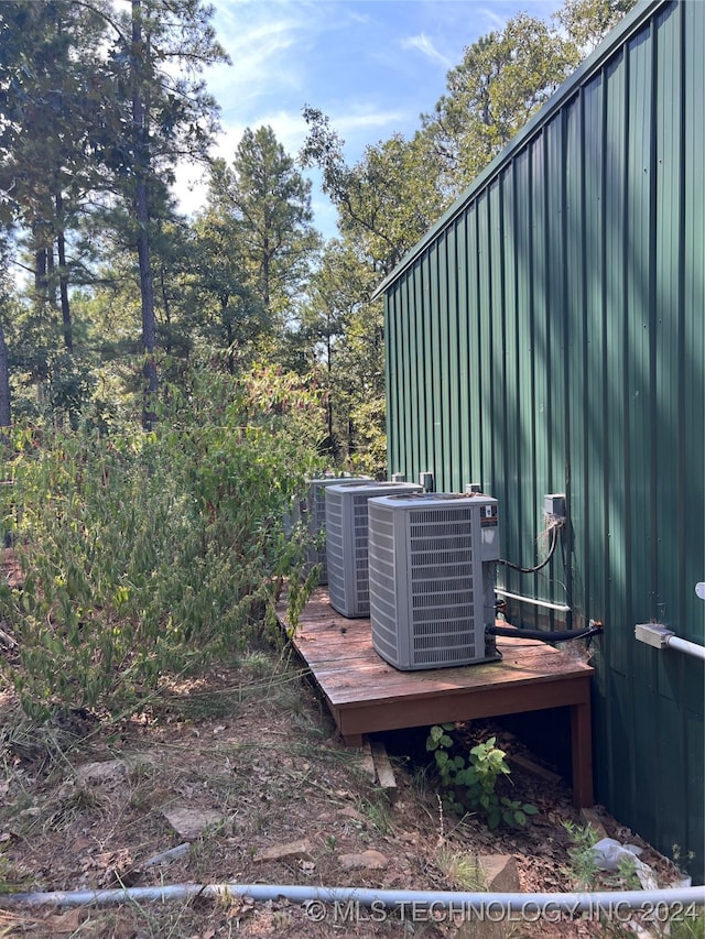 view of yard featuring a wooden deck and central air condition unit