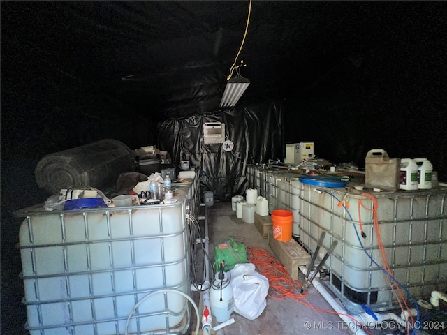 interior space with a wall mounted air conditioner and concrete floors