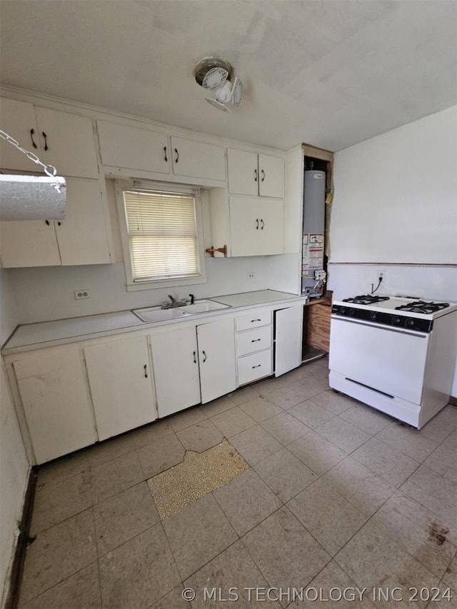 303 S B, Davis, OK 73030 - kitchen featuring white cabinets, light countertops, a sink, and gas range gas stove
