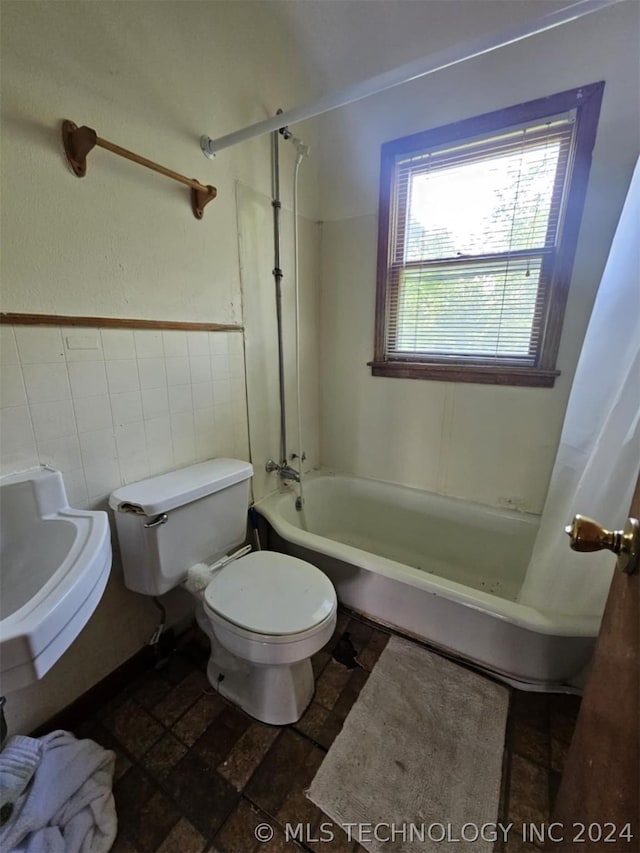 303 S B, Davis, OK 73030 - bathroom featuring toilet, a wainscoted wall, tile walls, and shower / bathtub combination with curtain