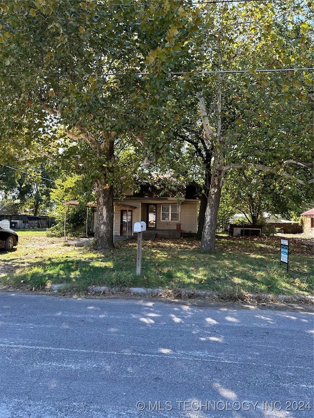 303 S B, Davis, OK 73030 - view of property hidden behind natural elements featuring fence