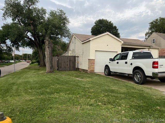 view of property exterior featuring a garage and a yard