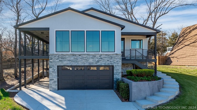 view of front of house with stucco siding, stairway, a front lawn, an attached garage, and driveway
