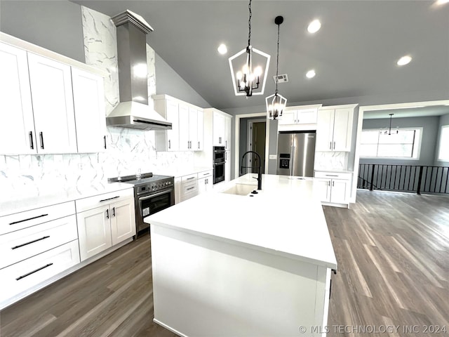 kitchen with wall chimney exhaust hood, pendant lighting, stainless steel appliances, a kitchen island with sink, and white cabinets