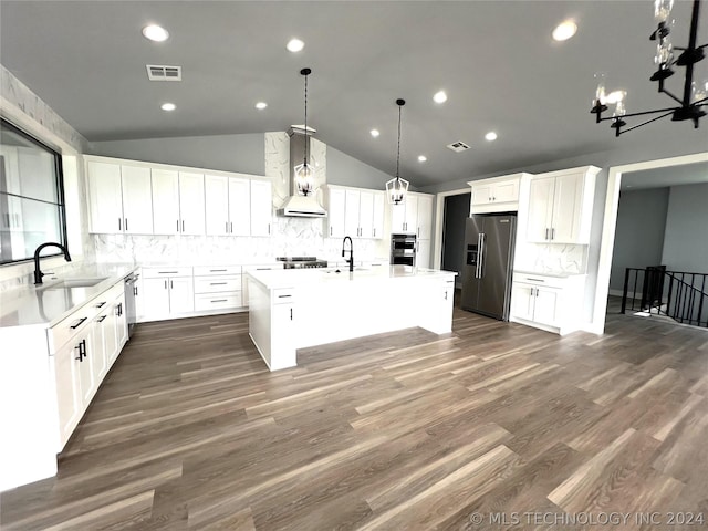 kitchen with a kitchen island, appliances with stainless steel finishes, sink, white cabinets, and wall chimney exhaust hood