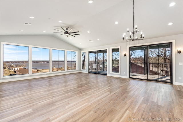 unfurnished living room with recessed lighting, visible vents, ceiling fan with notable chandelier, and lofted ceiling