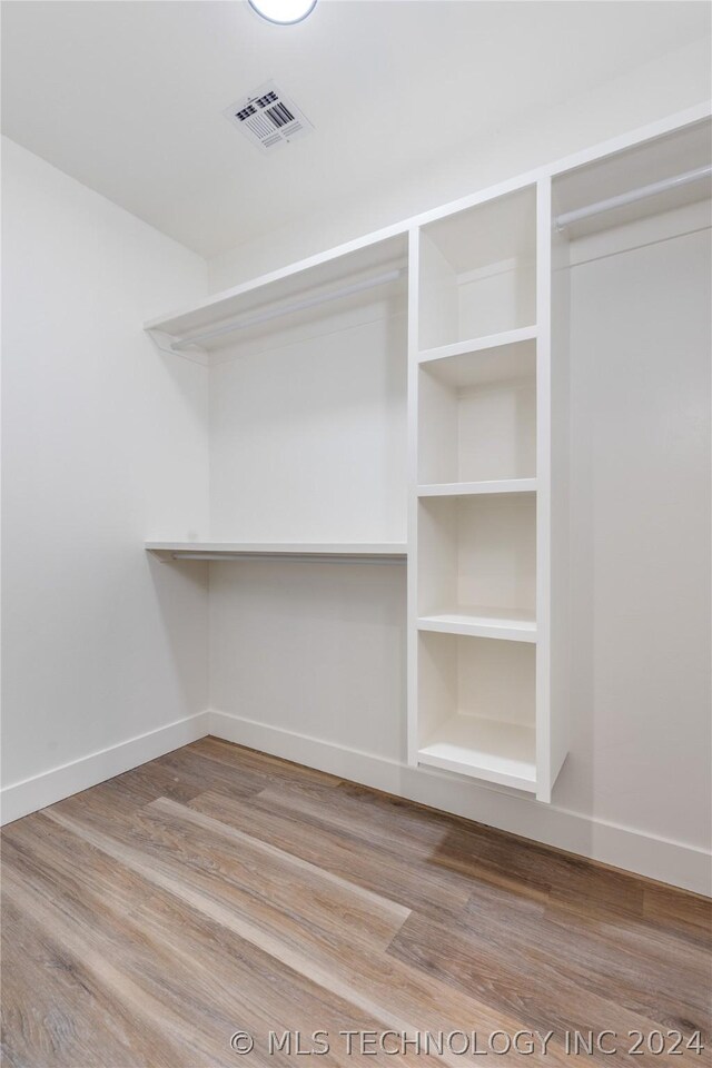 walk in closet featuring hardwood / wood-style floors