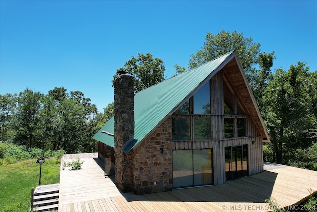 rear view of property featuring a wooden deck