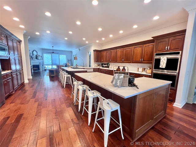 kitchen featuring appliances with stainless steel finishes, a large island, and a kitchen breakfast bar