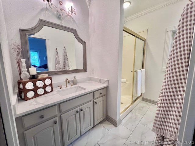 bathroom with ornamental molding, vanity, and a shower with door