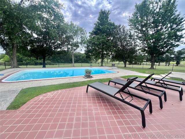 view of swimming pool featuring a patio area