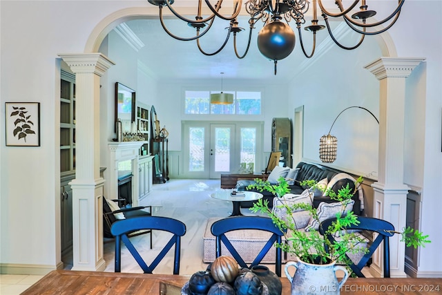 living room with crown molding, french doors, and ornate columns