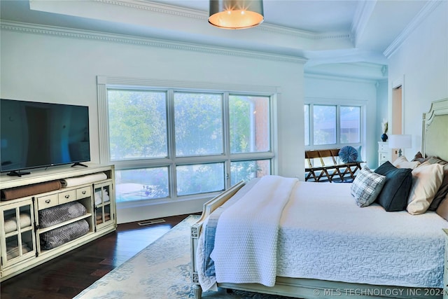 bedroom featuring a raised ceiling, ornamental molding, and dark hardwood / wood-style flooring