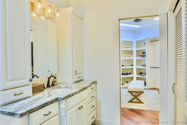 bathroom featuring vanity and hardwood / wood-style flooring