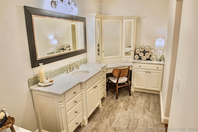 bathroom with vanity and hardwood / wood-style flooring