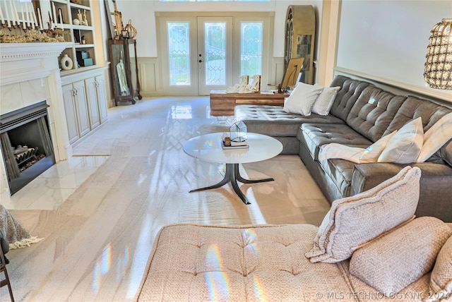 living room featuring a tile fireplace and french doors