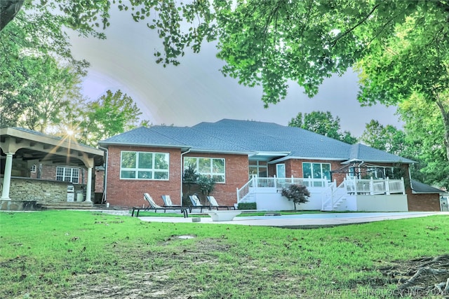 rear view of house featuring a lawn