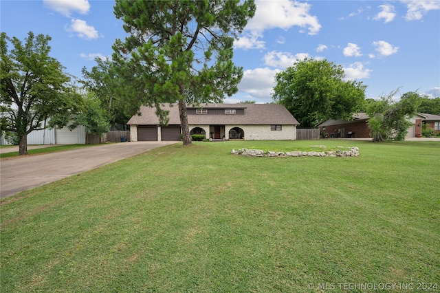 view of front facade with a garage and a front lawn