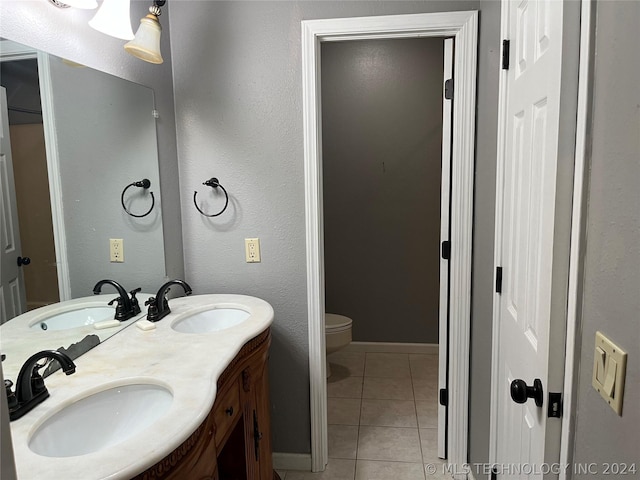 bathroom featuring toilet, vanity, and tile patterned floors