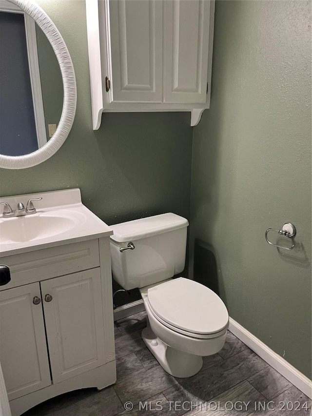 bathroom with toilet and vanity