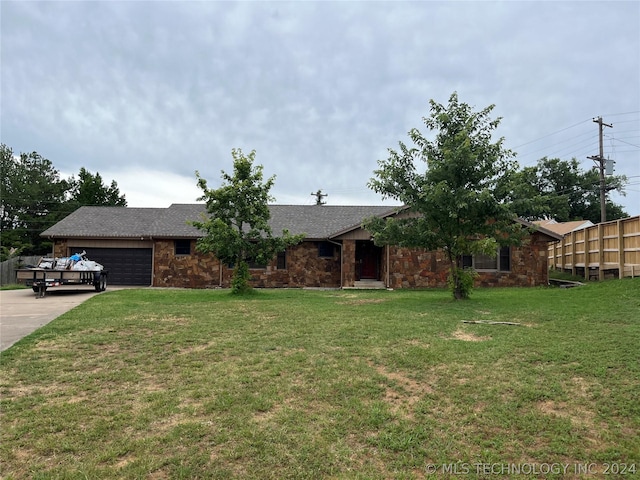 ranch-style home featuring a front lawn and a garage